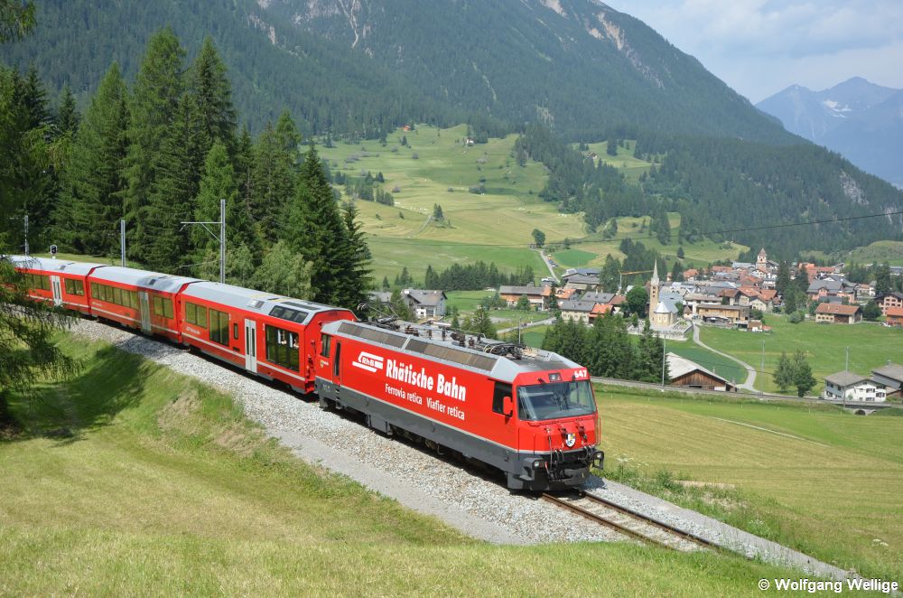Lok 647 vom Typ Ge 4/4 III der schmalspurigen Rhätischen Bahn hat am 1. Juli 2019 mit dem InterRegio 1129 (Chur - St. Moritz) vor wenigen Minuten den Ort Bergün hinter sich gelassen, der unten im Tal zu sehen ist.